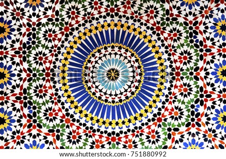 The colorful intricate patterns of an geometric mosaic decorate the walls of a kasbah in Morocco
