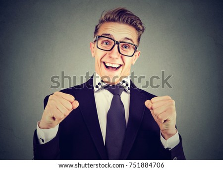 Happy excited young man in glasses  