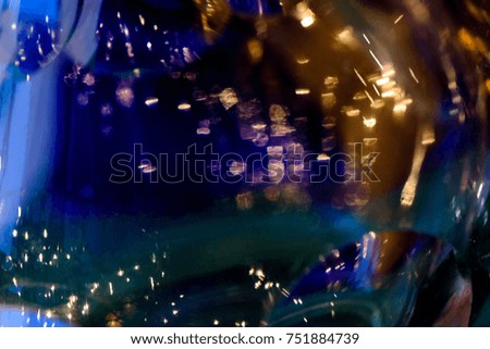 glitter vintage lights background. gold, blue and black. de-focused.