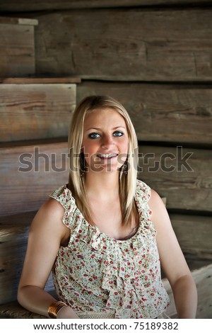 Portrait of beautiful teen girl sitting on wooden steps.