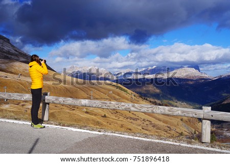 Young girl taking picturesin the Dolomites, Italy, Europe