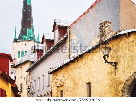 Street and St Olaf Church in the Old town of Tallinn, Estonia in winter