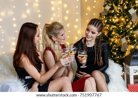 Picture showing group of girls having fun drinking wine or champaign, celebrating new year and having fun with sparklers
