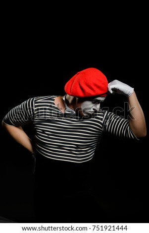 Male mime thinking and leaning on imaginary object. Professional actor showing a pantomime, imitating being in deep thought.