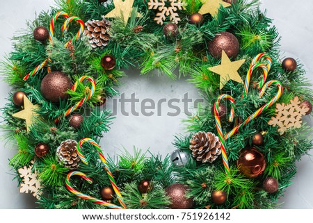 Holidays new year concept. Advent christmas door wreath with festive decoration on a cozy background. Flat lay top view
