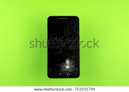 broken phone crack on the screen on a green background