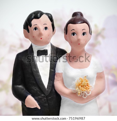 closeup of a couple wedding cake topper