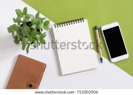 Blank notepad on with smart phone on desk.top view,flat lay Royalty-Free Stock Photo #752002906