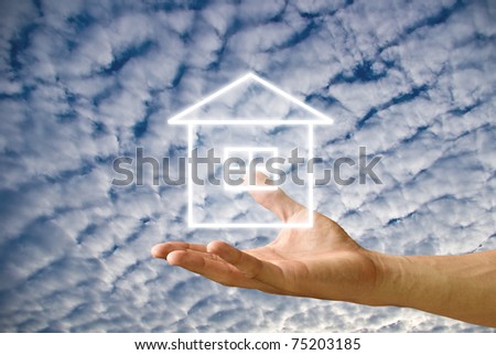 House icon in the hand with cloudy sky background