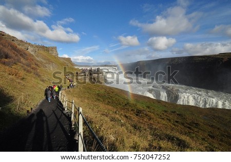 Trail to Gulfoss with rainbow, a famous waterfall in golden circle, Iceland (shade and noise are part of picture)