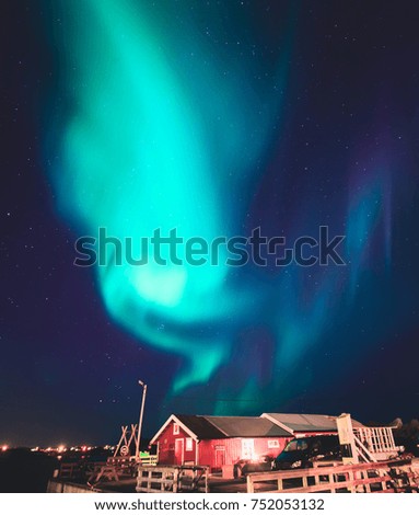 Beautiful picture of massive multicoloured green vibrant Aurora Borealis, Aurora Polaris, also know as Northern Lights in the night sky over summer Lofoten Islands, Norway, 
