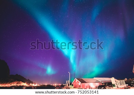 Beautiful picture of massive multicoloured green vibrant Aurora Borealis, Aurora Polaris, also know as Northern Lights in the night sky over summer Lofoten Islands, Norway, 
