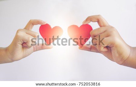 Handle two hearts made of paper isolate on white background Love Symbol lifestyle valentine day give sweetheart abstract concept romantic couple hope for a family living together one in heart forever