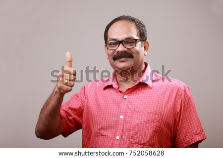 Middle aged man of Indian origin shows OK gesture Royalty-Free Stock Photo #752058628