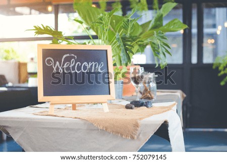 Blackboard sign with welcome message in coffee shop
