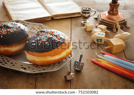 image of jewish holiday Hanukkah background with traditional spinnig top and doughnuts