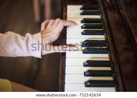 Focus One Female Hand Playing Wood Piano