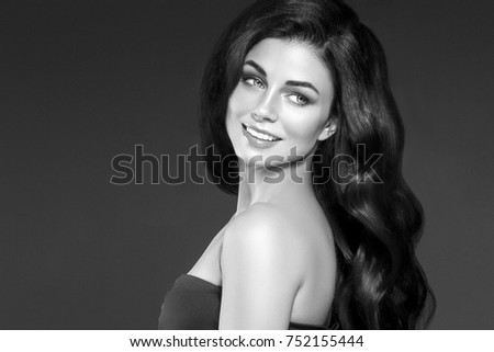 Adult woman portrait, skin care and healthy hair concept, beautiful skin and hands with manicure nails over black background black and white. Studio shot.