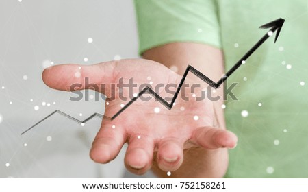 Businessman on blurred background holding hand-drawn arrow going up