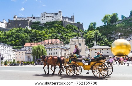 Tourists sightseeing in horse carriage in Salzburg, Austria Royalty-Free Stock Photo #752159788