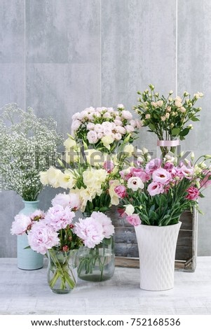 Beautiful flowers on grey, stone background, copy space.