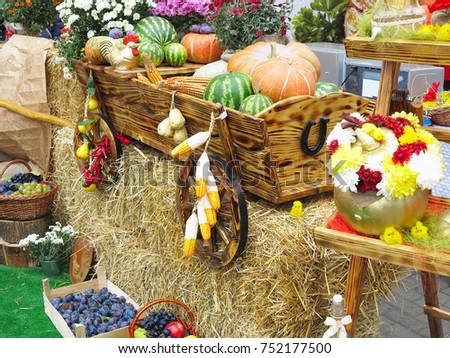 Vegetables and pumpkins on hay in a wooden cart, the season of harvest on the farm thanksgiving