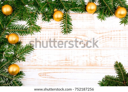 Christmas fir tree on white wooden background.