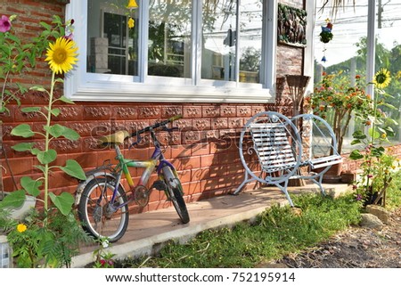 beautiful old bicycle bricks wall and ancient chair in Thailand.