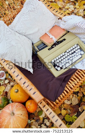 Autumn photo-shoot decoration; printing machine, pumpkins, yellow leaves, books, pillows