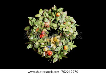 Artificial  Christmas wreath with decoration of fruits and ornaments