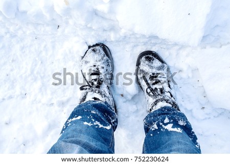 a winter walk through the snow in boots
