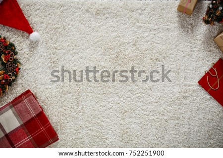Photo of carpet above the floor. Free space for your decoration. Red santa claus hat.