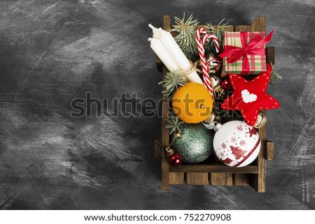 Boxes with gifts for Christmas and various attributes of holiday on a dark background. Top view, copy space