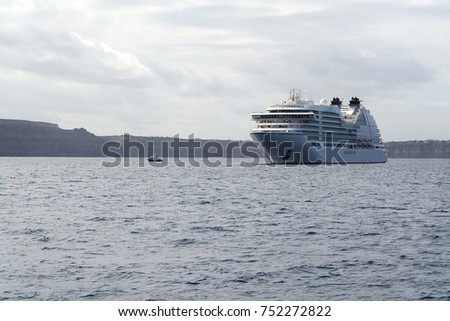 Cruise ship off the coast of Santorini on a cloudy day.