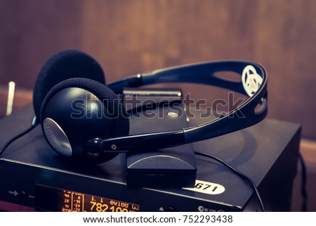 headphones used for simultaneous translation equipment simultaneous interpretation equipment wireless language headphones set on the chairs in conference room. Monochromatic