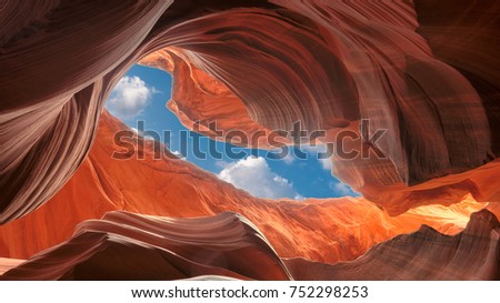 Sunlight reflected off of the red rock curves of the Antelope Canyon Slot Canyons in Page, Arizona. This shot was taken in Lower Antelope Canyon. Antelope Canyon was carved by flash floods.