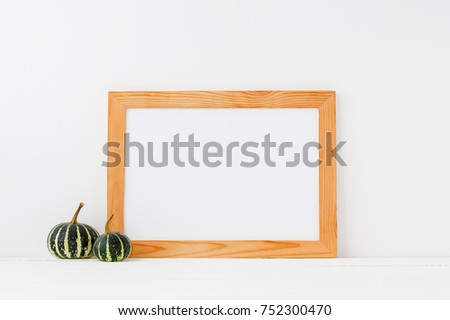 Empty wooden frame mockup with pumpkins. 