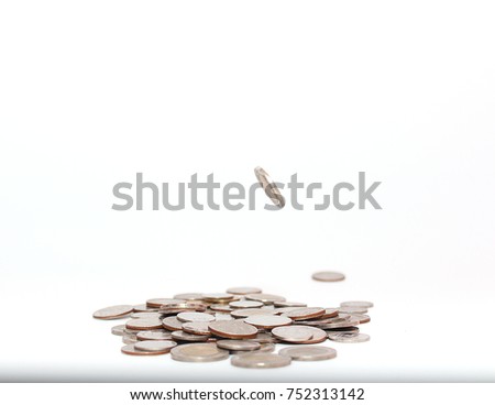 Concept of investing and saving money. Coins fall from high to whole.Falling coins money isolated on the white background.