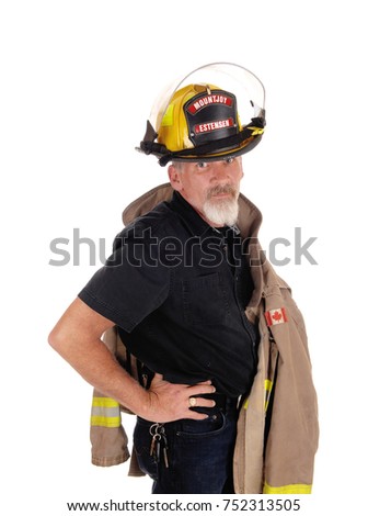 A firefighter man with his jacket over his shoulder and helmet on his
head, looking into the camera, standing isolated for white background
