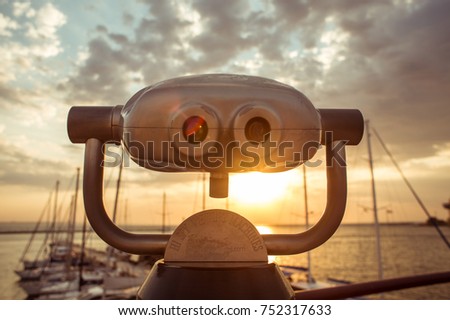 Sunrise in the port through binoculars at the observation deck overlooking the horizon