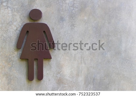 Women's Bathroom Icon Sign (Restroom or Toilet room) on the cement wall