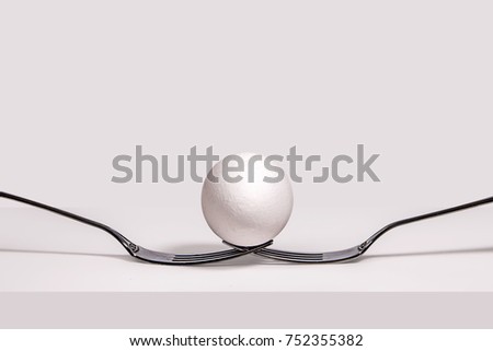egg and fork on white table, still life, horizontal