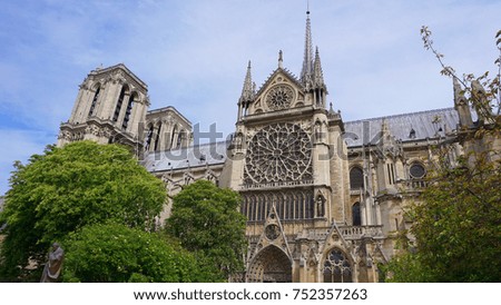 Photo of iconic cathedral of Notre Dame on a cloudy spring morning, Paris, France