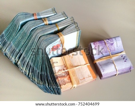 Bundle of money. Malaysia Ringgit (MYR) RM100, RM50, RM20, RM10 with isolated brown background.