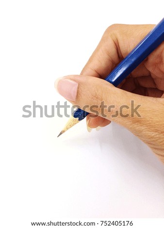 The pencil in hand writing on paper when study in school or draw picture