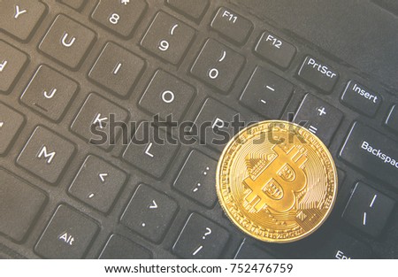 Bitcoin coin placed on modern black notebook keyboard. Close-Up photo Bitcoin , exchange virtual value, crypto digital money.Stock trading through internet.Selling big amounts, real estate.