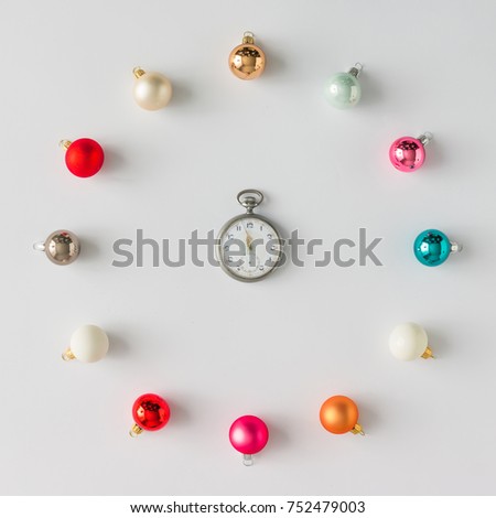 Colorful Christmas baubles decoration with vintage watch. Flat lay. Holiday concept.