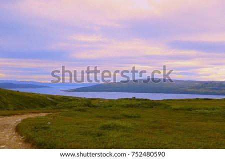 Lapland landscape of the tundra with a bay and a blue sky
