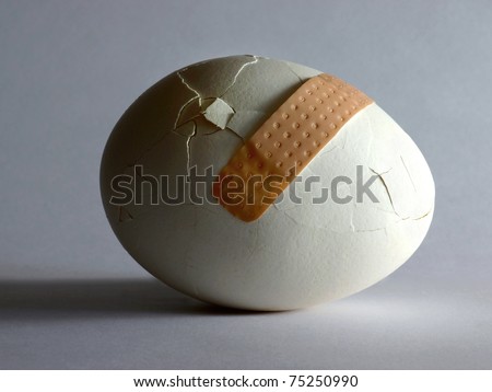 Broken egg with sticking plaster
