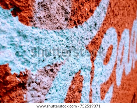 Blue spray paint on a red wall. Urban background concept